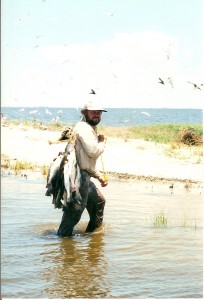 Capt. Clay Bring A Stringer Of Speckled Trout To The Beach