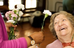 elder-woman-get-flower-300x198